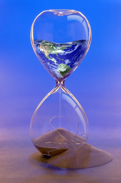 Earth in a Broken Hourglass Concept image. Imagen de la Tierra por NASA Imagen de stock