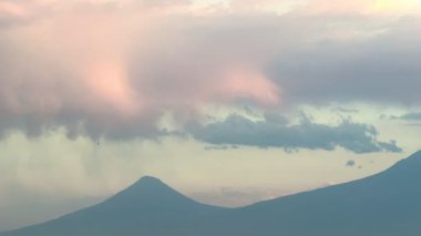 Bulut örtüsü ve günbatımında Türkiye 'nin Ararat Dağı etrafında uçan bir NATO savaş uçağı. Eylül 2025