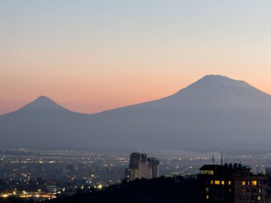 Gün batımında Ararat Dağı, arka planda şehir olan dağların manzarası, Erivan 'ın güzel manzarası. Yüksek kalite