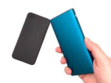 Blue power bank on a white background, black phone and portable charger, dead phone, carrying power banks in luggage, energy, battery Power bank for charging mobile devices. Portable charging solution. High quality