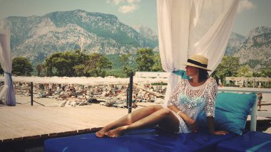 girl resting in a straw hat