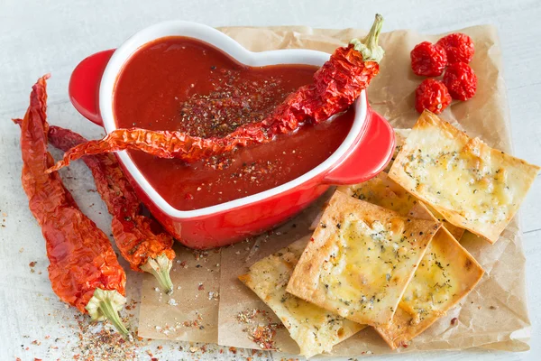 Spicy tomato soup with red pepper and cheese crisps