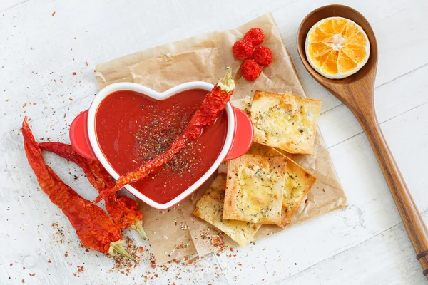 Top view of a spicy tomato soup with chili pepper and cheese crackers — Stock Image Top view of a spicy tomato soup with chili pepper and cheese crackers Stock Picture