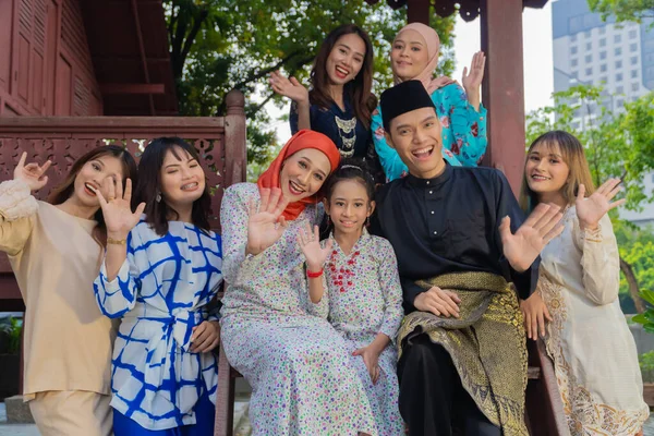 A group of malay people at the wooden house celebrating Hari Raya festive