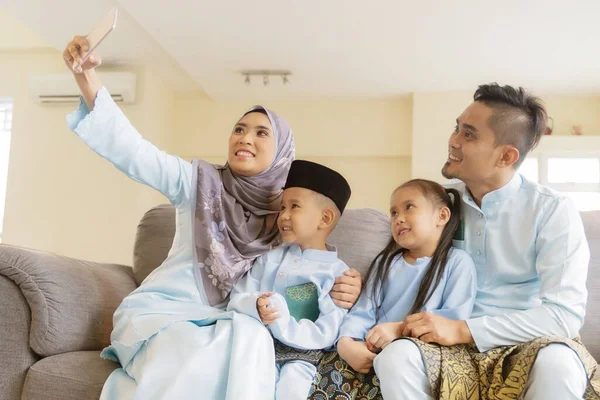 Eid Mubarak celebration moment, Malay family taking selfie