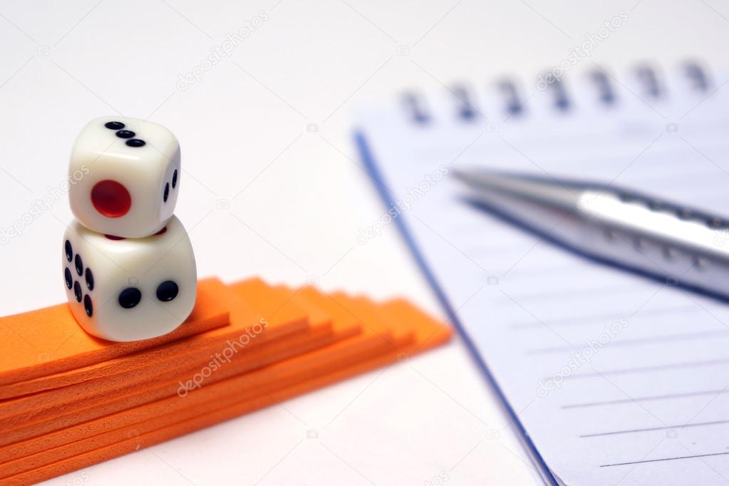 Dices with pen and notepad
