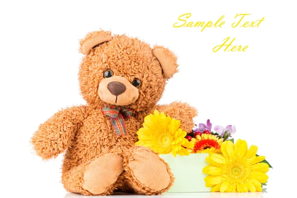 Bos bloemen en een teddybeer — Stockfoto
