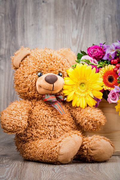 flowers in the box and a teddy bear