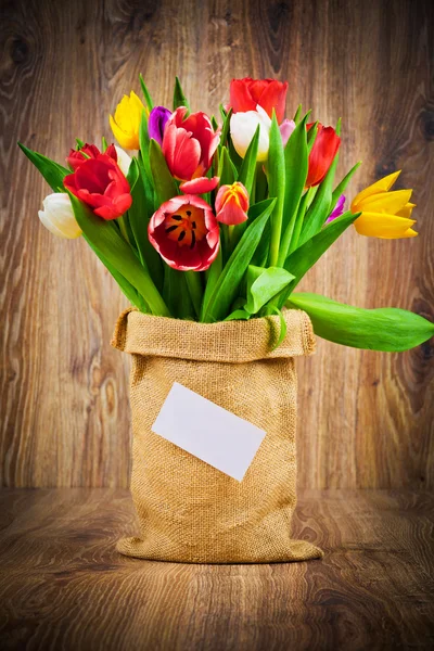 Beautiful tulips in sack — Stock Photo, Image