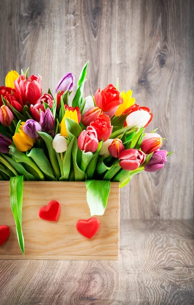 Kleurrijke tulpen in houten kist — Stockfoto