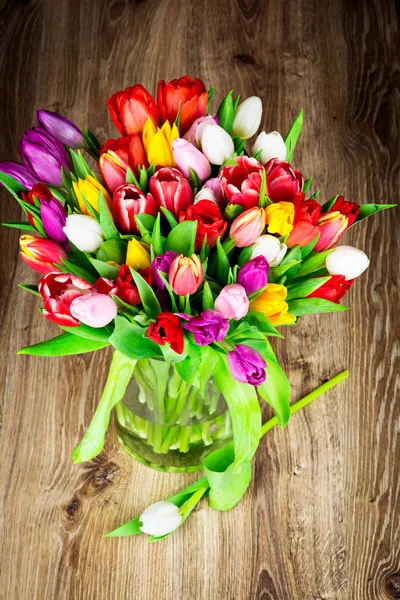 Bright tulips in glass vase — Stock Photo, Image