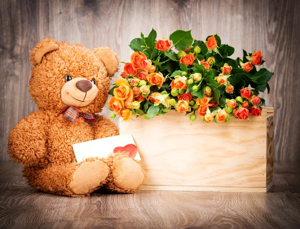 Roses in box and teddy bear with card — Stock Photo, Image
