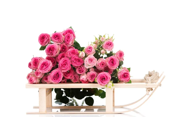 Roses on wooden sleigh — Stock Photo, Image