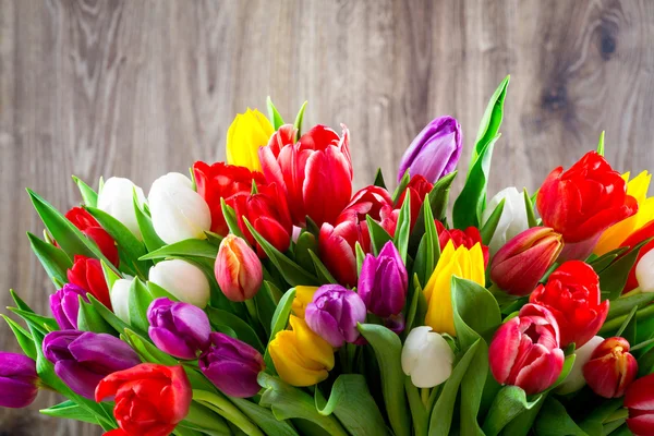 Tulips on wooden background — Stock Photo, Image