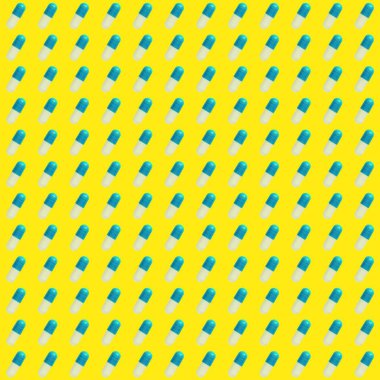 Sarı arka planda mavi hapların deseni