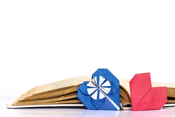 Open book with paper heart isolated on white background — Stock Photo, Image