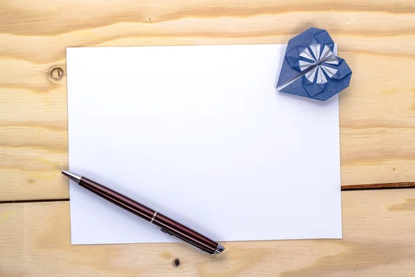 Valentines card with origami blue heart on wooden table — Stock Photo, Image