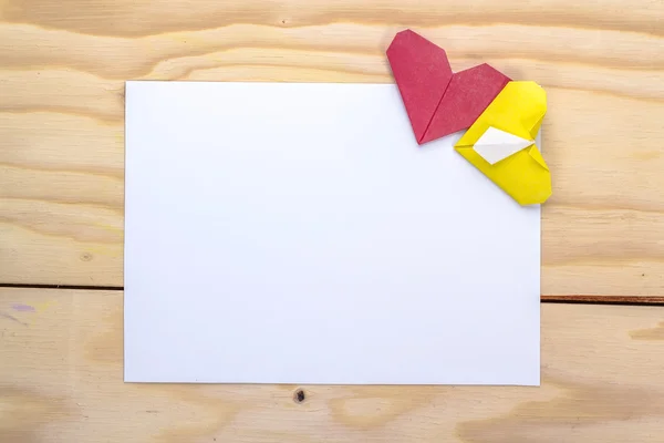 Valentines card with origami yellow and red hearts on wooden table — Stock Photo, Image