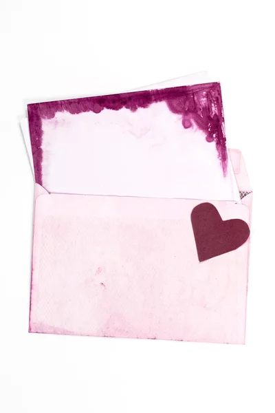 Open vintage envelope with pink pages and heart — Stock Photo, Image