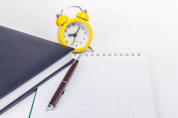 Opened notebook and alarm clock — Stock Photo, Image