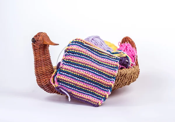 Striped knitted fabric in a basket with wool — Stock Photo, Image