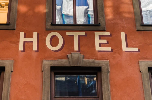 Hotel sign between windows — Stock Photo, Image