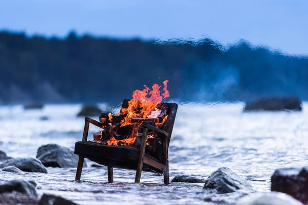 Old armchair in fire — Stock Photo, Image