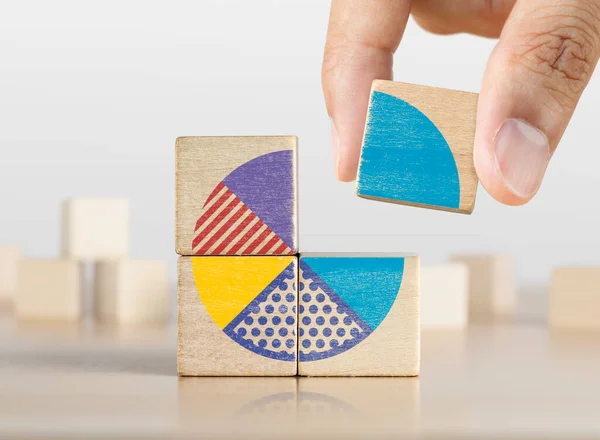 Market share, business opportunity, market growth, increase market share or business concept. Businessman grabs a piece of wooden blocks with pie chart graphic.