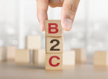 B2C sözcüğüyle ahşap blokları elle düzenlemek. İş tüketici pazarlama kavramına.