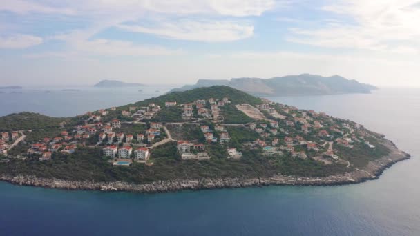 Island with villas and houses in the town of Kas of Antalya, Turkey. Aerial view 4K. — Stock Video