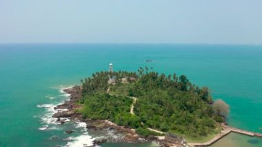 SriLanka 'daki güzel tropik ada ve beyaz deniz feneri. Hava görüntüsü 4K.