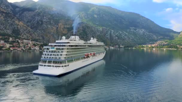 Cruise liner ship swimming at blue adriatic sea on mountains landscape port of Kator, Montenegro. KOTOR, MONTENEGRO - JULE 24, 2021 — Wideo stockowe