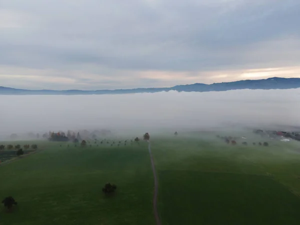 Panoramic foggy landscape with mountains in morning