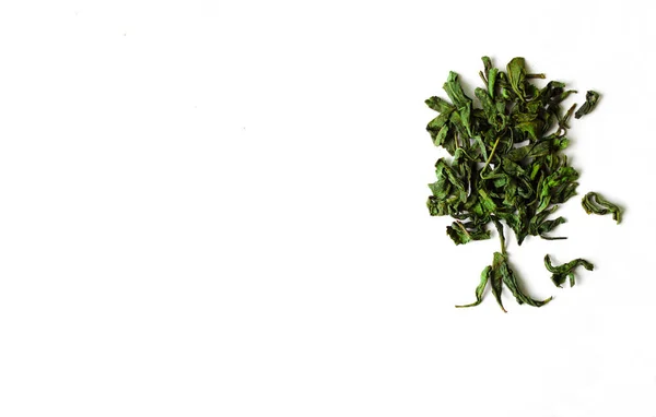 Green tea leaves in tree shape on white isolated background.Green dry tea leaves — Stock Photo, Image