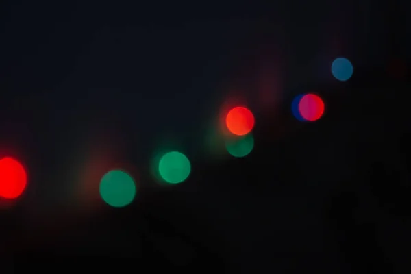 Colored Bokeh Lights On Black Background.Defocused Image Of Illumified Lights.Boke. — 스톡 사진