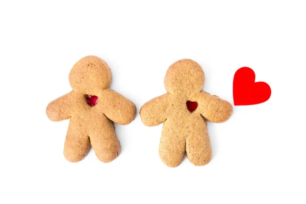 Um par de amantes de gengibre com corações isolados em um fundo branco. Biscoitos de Natal com amor. Imagens De Bancos De Imagens