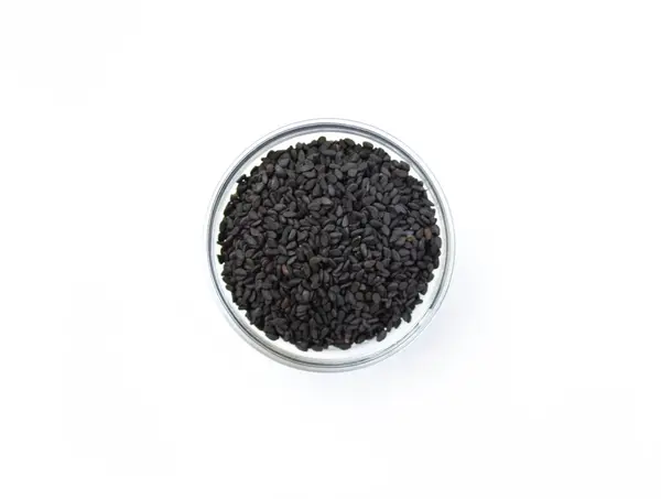 Black sesame seed in glass bowl on white isolated background, top view — Stock Photo, Image