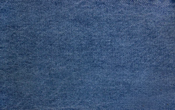 Texture en gros plan du tissu ou du tissu de couleur denim en couleur denim. Texture du tissu de fond en denim — Photo