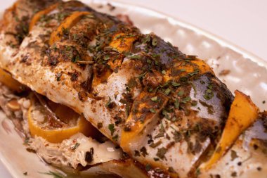 Limonla doldurulmuş balık tabakta çapraz görünüm