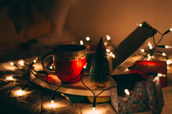 Big mug with Christmas decoration around laptop