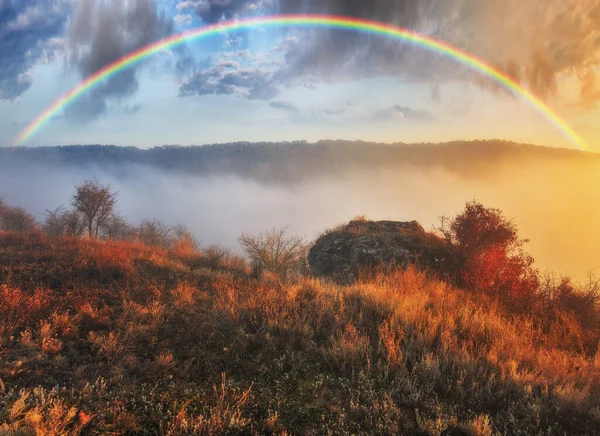 Rainbow with clouds over the canyon. autumn landscape