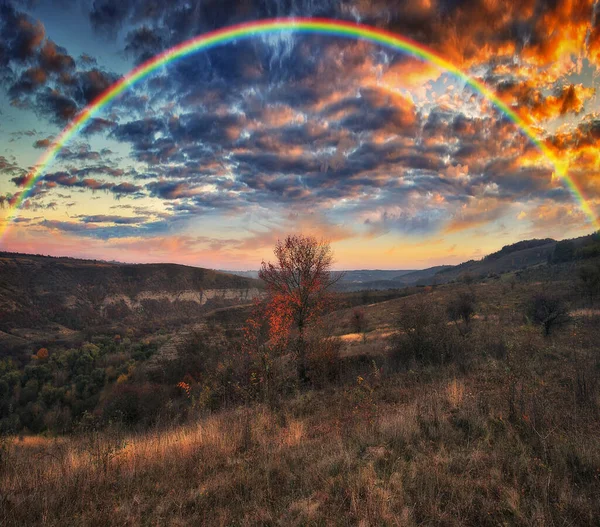 Rainbow with clouds over the canyon. autumn landscape