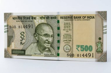 Beyaz arka planda para ve bozuk paralarla çekilmiş lego evi oyuncağı.