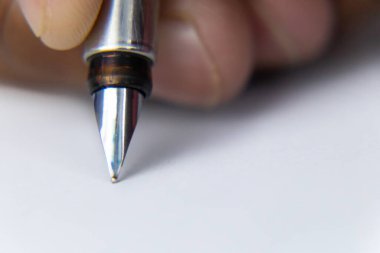 Front shot of a red school bag with an umbrella put in it and a pen stand in the left shot against blackboard -fun and school concept