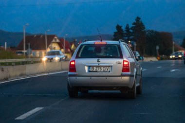 Asfalt yolda hareket halindeki bir araba, caddedeki arabanın arka manzarası. Bükreş, Romanya, 2020