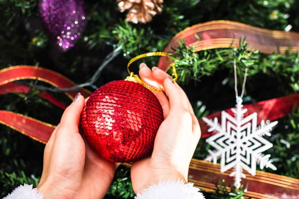 Hands Holding Christmas Ornament Front Christmas Tree Decorating Fir Branches — Stock Photo, Image