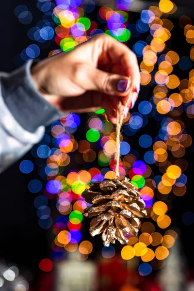 Holding Christmas Pine Cone Decoration Isolated Background Blurred Lights December — Stock Photo, Image