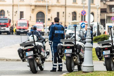Romanya 'nın başkenti Bükreş' te COVID-19 'un yaygınlaştığı 2020' de sokağa çıkma yasağı ihlallerini önlemek için, motosikletli polis memuru ve Romen Polisi (Politia Rutiera) devriye geziyor.
