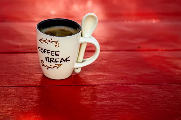 Cup of fresh made coffee on wooden background