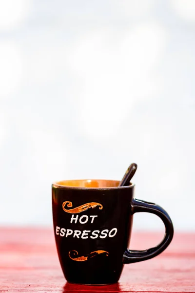 Cup of fresh made coffee on wooden background